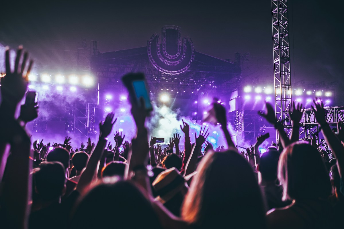 A crowd sharing a night of live music under colourful lights